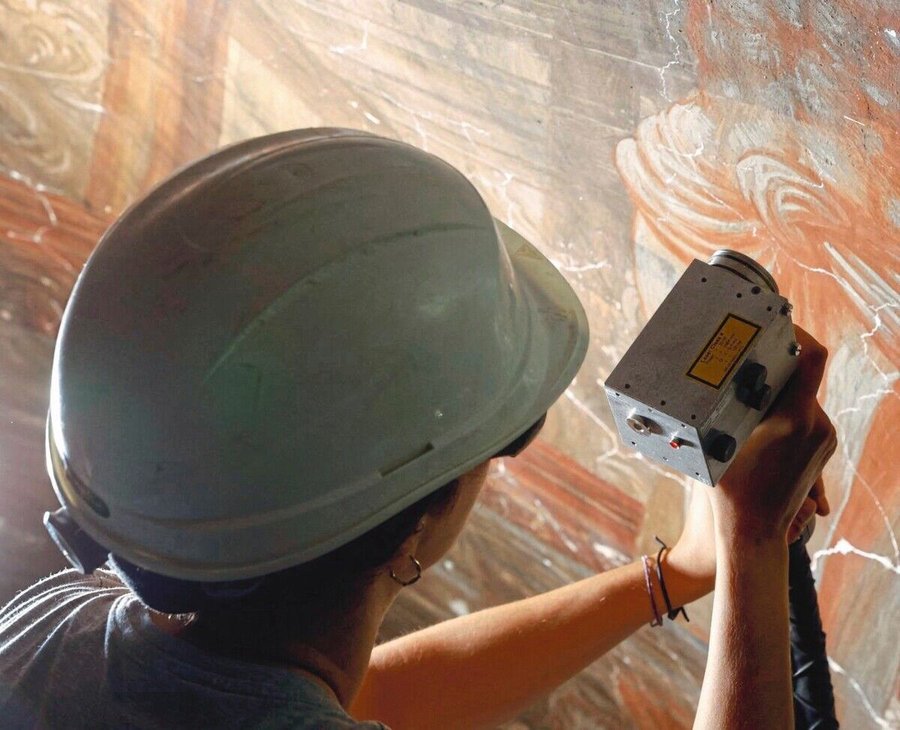 The_conservation_and_restoration_technician_applies_a_laser_during_restoration_work_on_the_baroque_church_of_the_Santos_
