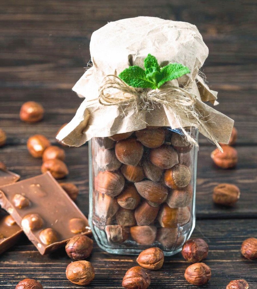 
jar_of_nuts_and_hazelnuts_on_a_wooden_background